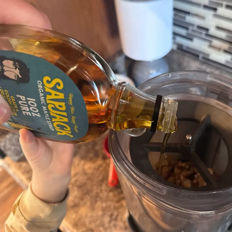 toddler helping pour 2-3 Tbsp 100 percent maple syrup into m1 milk chamber